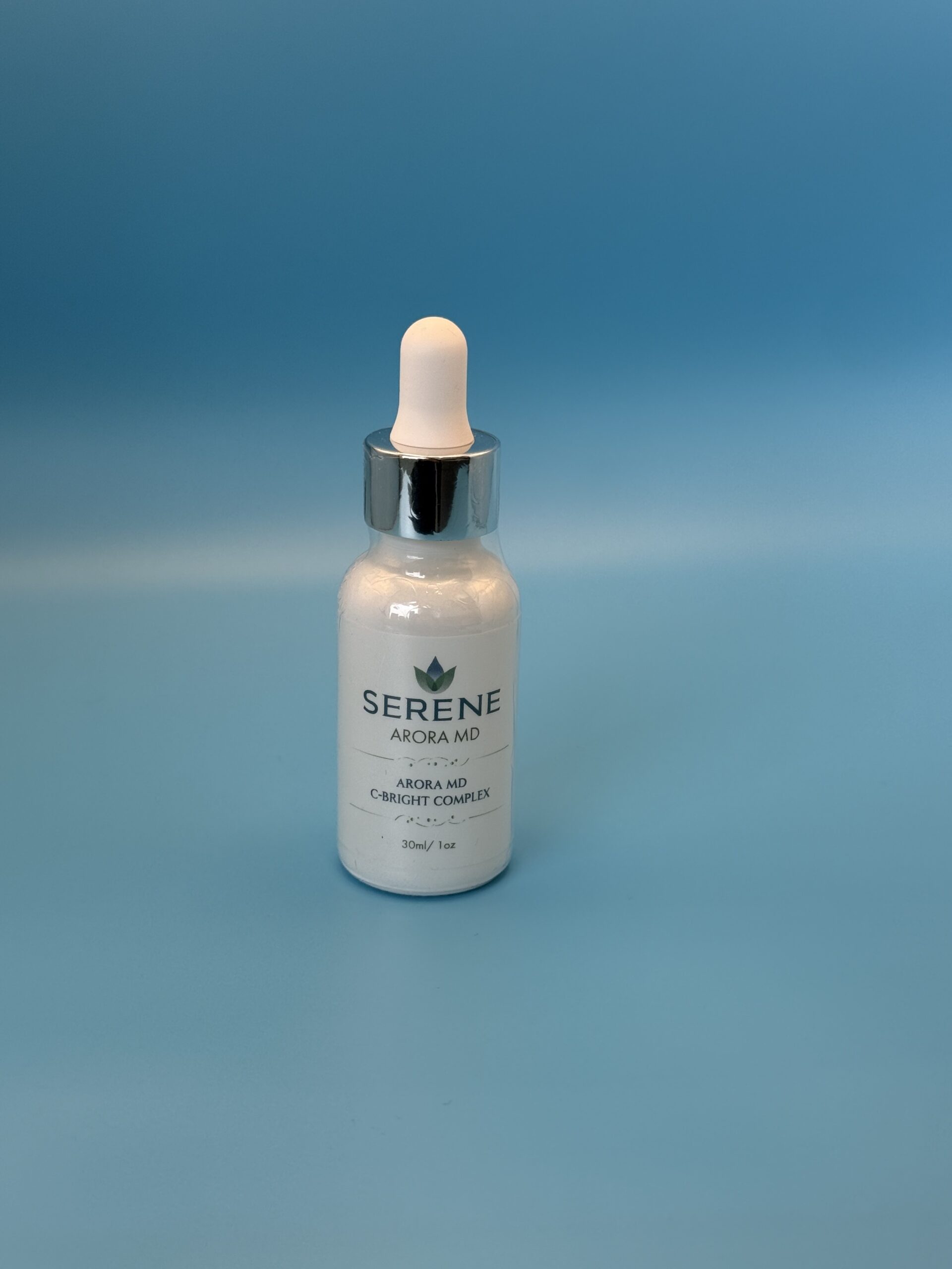 High-potency Arora MD C-Bright Complex 20% Vitamin C Serum in an elegant white dropper bottle against a clean minimalist background.
