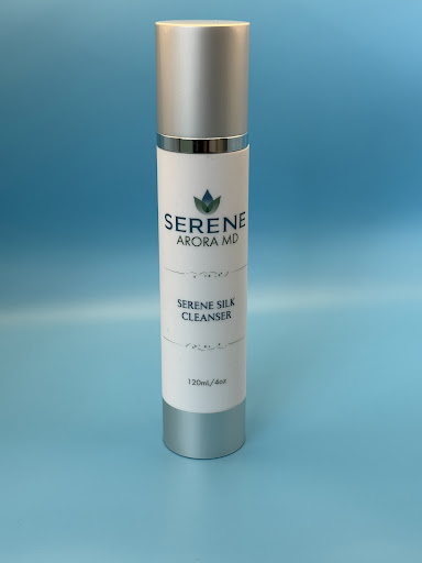Serene Silk Cleanser elegant white pump bottle on a clean minimalist background